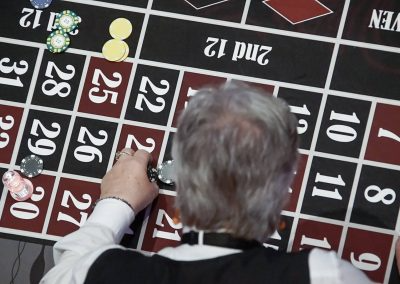 A man moves his poker chips on the poker table.