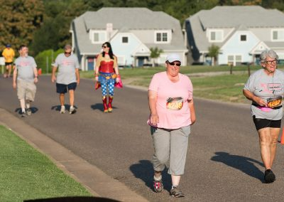 Two older women walk in a fundraiser race for breast cancer