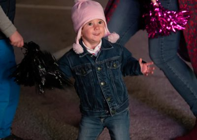 A little girl wearing a pink beanie and a denim jacket