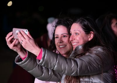 Two younger women smile take a photo together