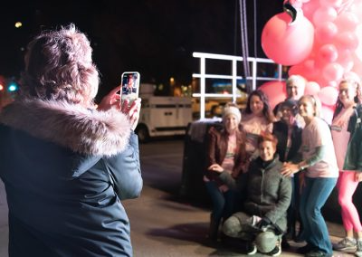 A woman takes a photo of a large group of women