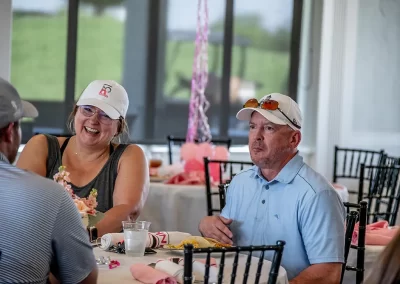 A man and woman chat while eating lunch at event