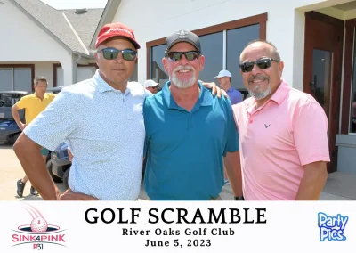 Three male golfers at the club house wearing sunglasses. Two on the left have hats and two on the right have beards