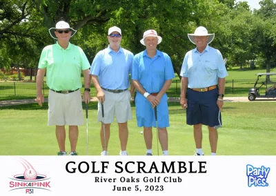 four men in golf polos smiling on golf course with whit hats