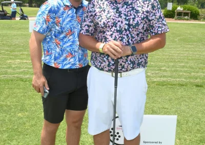 2 men in colorful shirts at golf event