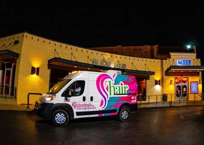 Colorful van parked outside of theatre entrance