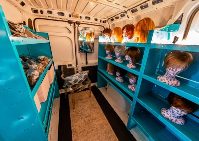 Van full of wigs on mannequin heads for breast cancer survivors