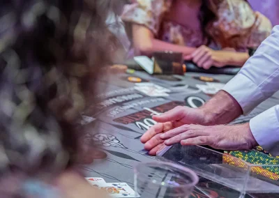 A croupier holds his hands across the game table