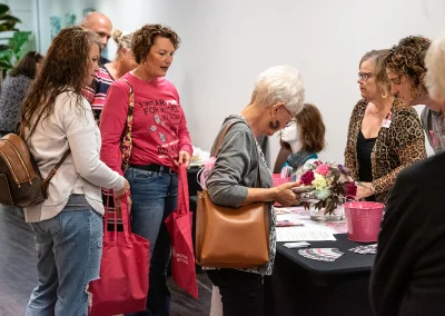 A group of women gather goodies from booths at the survivorship expo.