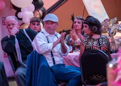 Guests clapping while seated at table