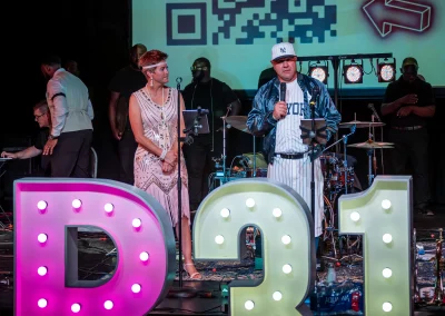 Man and woman speaking on stage