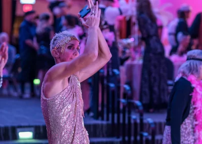 Woman clapping to music while dressed in a sparkly vintage costume