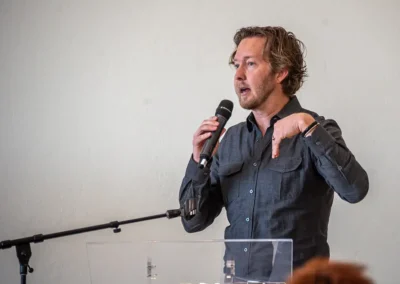 A man is standing at a podium and talking into a microphone