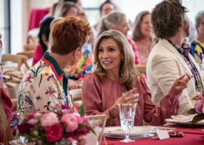 Two speakers discuss together at their table