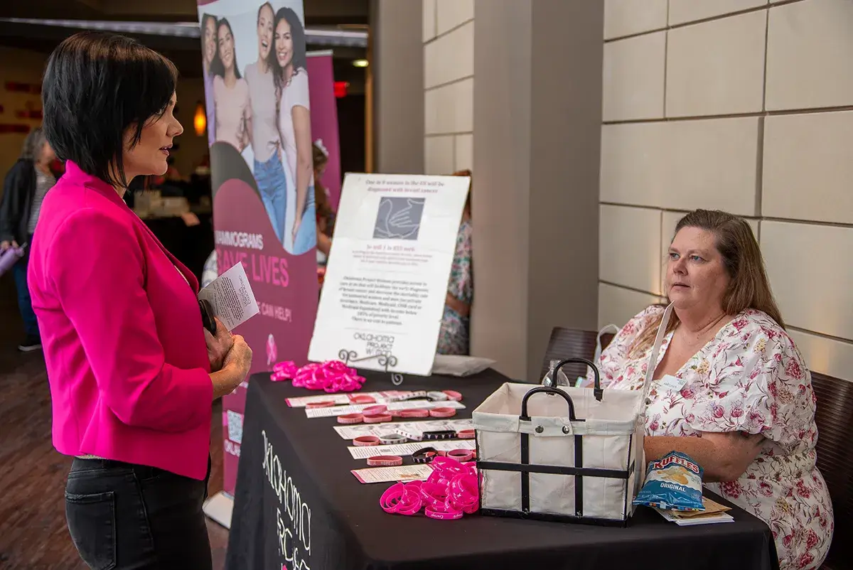 OKC-Expo A woman talking with an exhibitor at the breast cancer survivorship expo