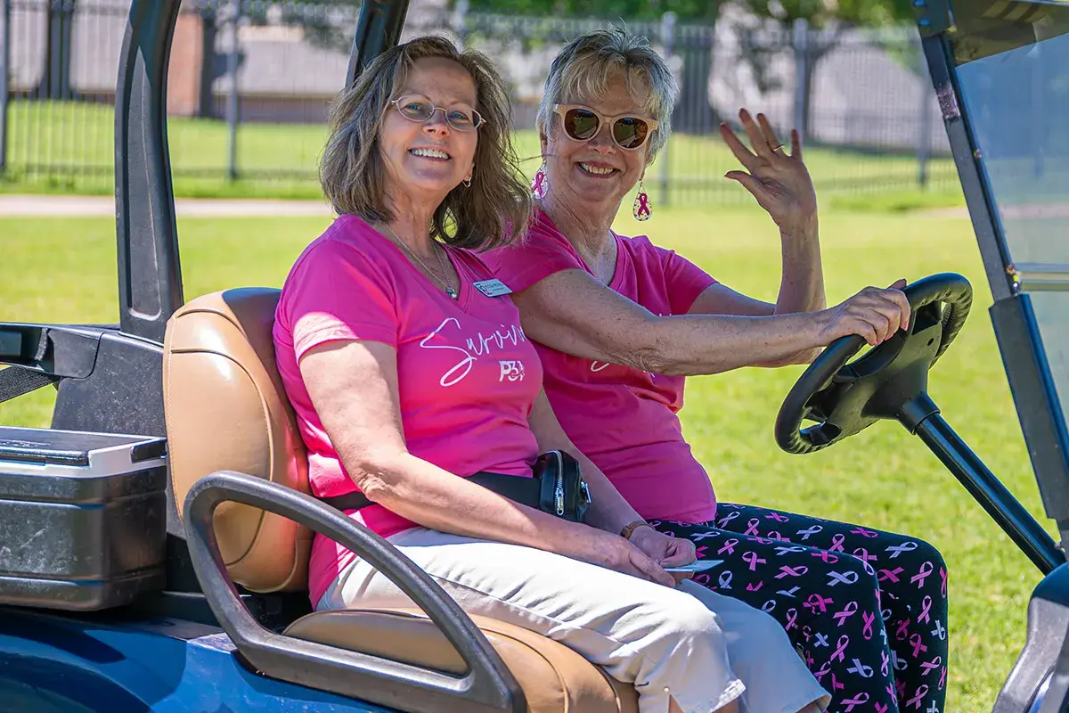 sink-4-pink-golf Two women riding on a golf cart