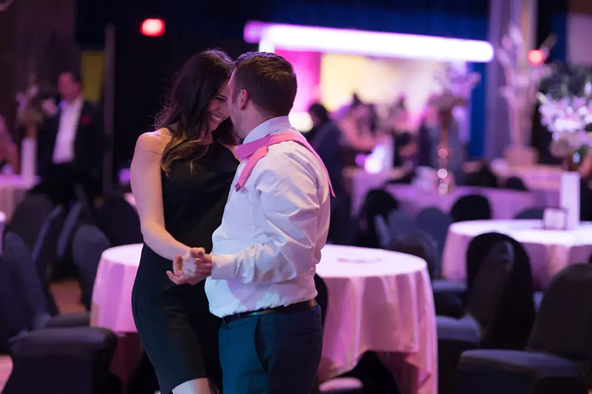 Woman and man dancing at Paint the Town Pink Gala