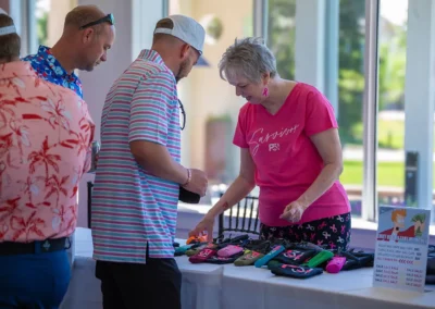 A P31 volunteer talking with a man at the merch table