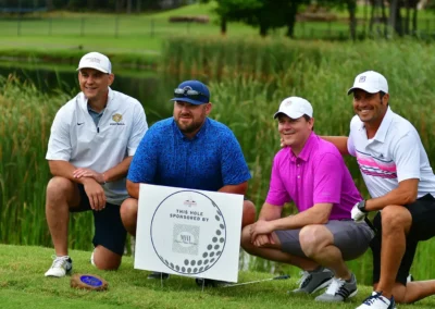 Sponsors kneeling by their sign