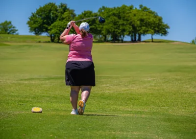 A woman hitting a golf ball